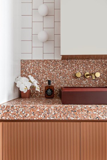 bathroom with minimalist sconces above vanity