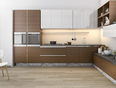 Kitchen with dark wood bamboo cabinets, wood floors.