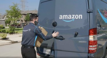 amazon delivery truck and driver with amazon boxes