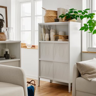A white cabinet with sliding doors from IKEA