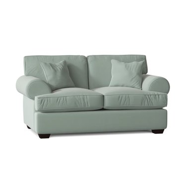 mint loveseat with plush cushions