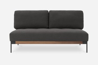 dark gray button-tufted two-seater armless sofa