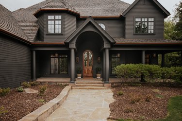Black house with dark brown roof