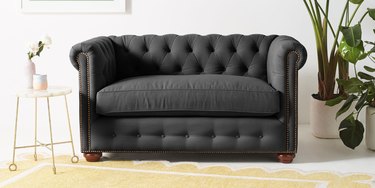 Anthropologie dark gray petite chesterfield loveseat with rolled armrests
