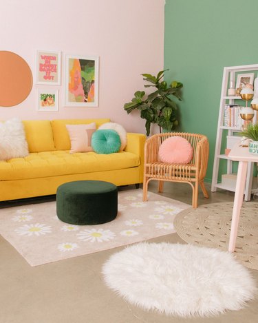 Living room with yellow sofa and green and pink walls.