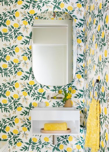 Bathroom with lemon wallpaper.