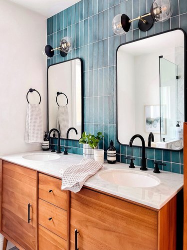 midcentury modern bathroom lighting idea with teal backsplash tile