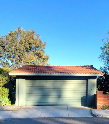 Green garage and door with red tile roof