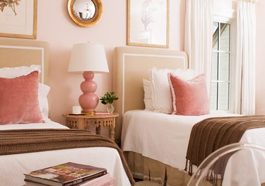 bedroom with tan beds and pink walls