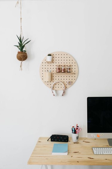 round pegboard hanging on wall in office