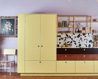 Kitchen with yellow cabinets, lilac walls.