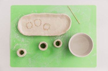 Attach the cylinders to the clay platter.