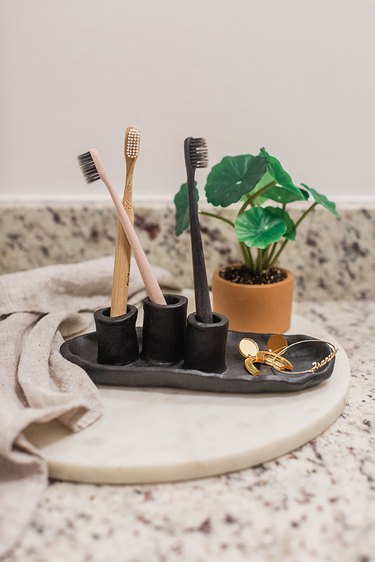 Air-dry clay toothbrush holder on bathroom vanity