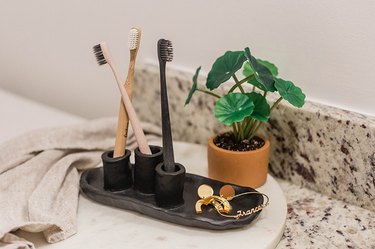 Air-dry clay toothbrush holder on bathroom vanity