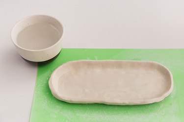 Shape the edges of the oval you cut out so that it has walls like a platter or bowl.