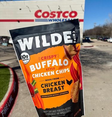 Wilde Buffalo Style Chicken Chips in front of a Costco warehouse
