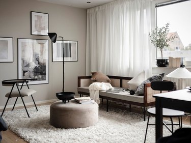 Living room with tan paint and black accents.