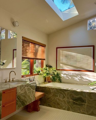 green marble bathroom with skylight