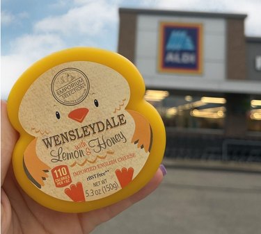 Hand holding Aldi's Emporium Selection Wensleydale cheese with Lemon and Honey