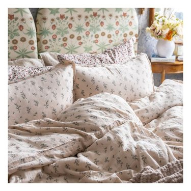 messy bed with pink floral bedding