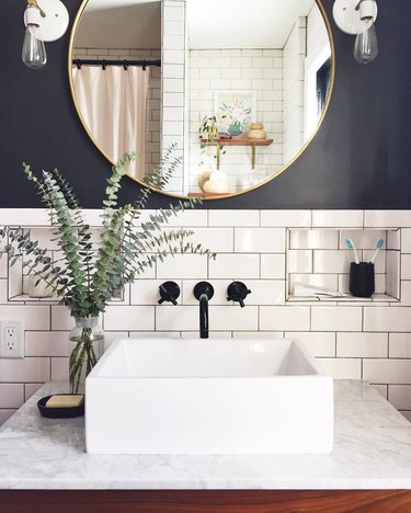 black and white farmhouse bathroom idea with subway tile and exposed bulb sconces