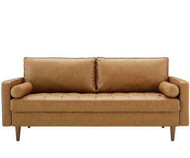 light brown vegan leather sofa with bolster pillows