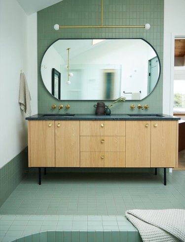 midcentury modern bathroom with green tile on walls and floor