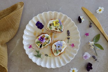 Whipped feta dip on crostini garnished with edible flowers