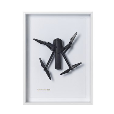 framed wall art with black drone-like figure