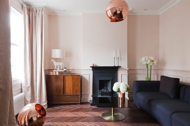 dusky pink living room with rose gold pendant