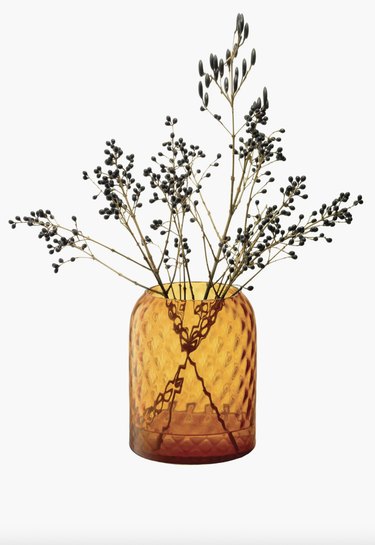 orange glass vase with flowers