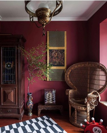 maroon room with wood furniture and patterned rug