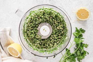 Parsley, sunflower seeds, and Parmesan cheese in a food processor