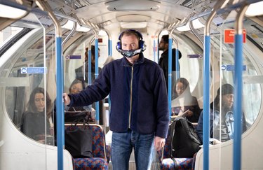 man wearing dyson zone on bus