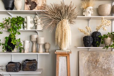 Wall shelving with plants and pottery