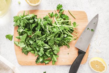 Chopped parsley on a wooden cutting board