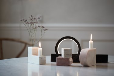 stone sculptures serving as vases and candle holders