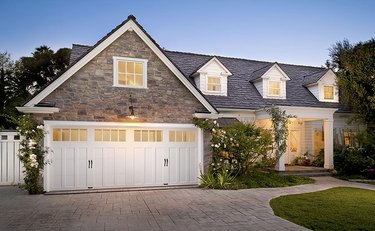 A Colonial-style garage door on a tan brick home