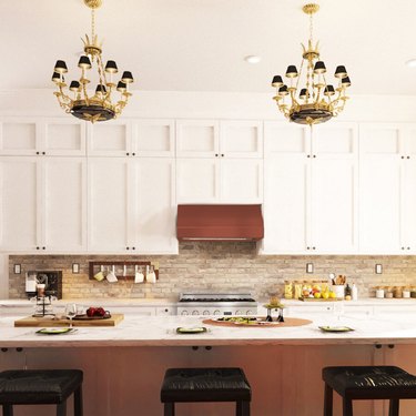 White kitchen, copper hood, white range.