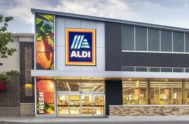 Aldi storefront with the logo in front of gray skies