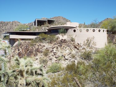 Frank Lloyd Wright's Circular Sun House pictured on a cliffside stuffed with cacti.