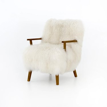 white plush armchair with wooden accents