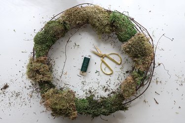 Sheet moss attached to grapevine wreath with floral wire