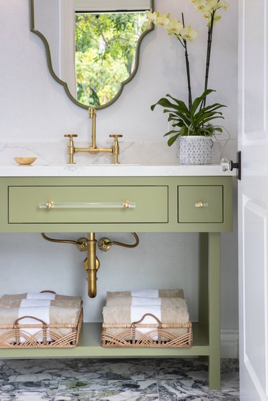 Bathroom with white walls and sage green sink