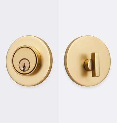 Two sides of a brass deadbolt lock