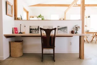 white desert style home office with wooden details and built-in desk