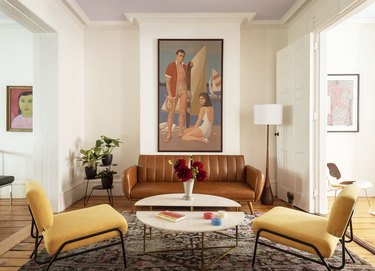 The Novogratz living room with leather sofa and two side chairs
