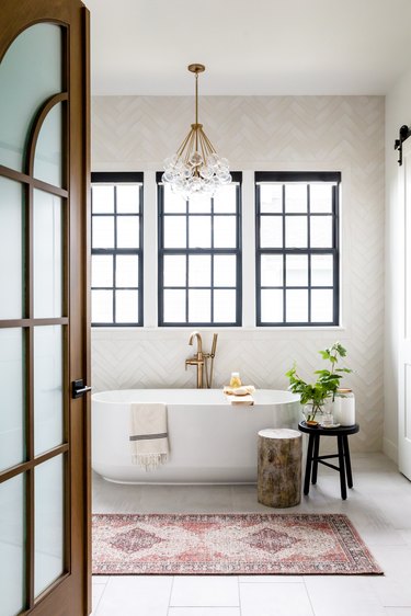 modern farmhouse bathroom idea with glam touches, including bubble chandelier and brass hardware