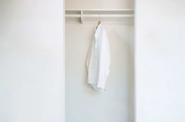 Closet with shirt hanging.