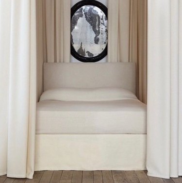 Off white canopy bed with mirror.